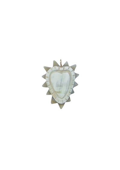 Decorative heart-shaped necklace charm with a starburst design on a white background